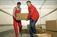 Moving men inside a moving van holding a box