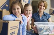 Family sitting among moving boxes