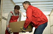 Moving men holding a box