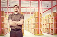 Smiling man standing in front of warehouse storage